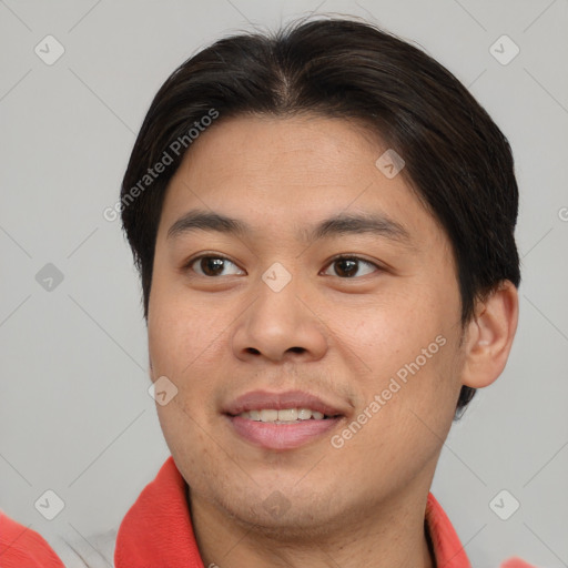 Joyful asian young-adult male with short  brown hair and brown eyes