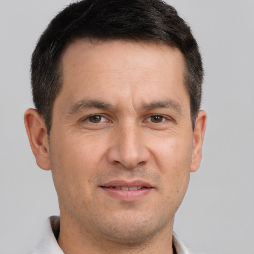 Joyful white adult male with short  brown hair and brown eyes