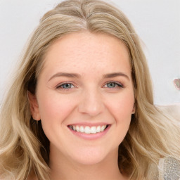 Joyful white young-adult female with long  brown hair and blue eyes