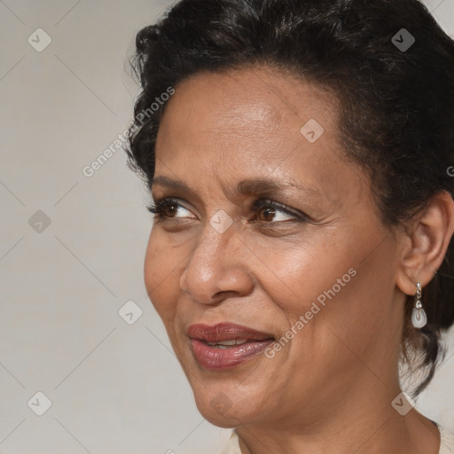 Joyful black adult female with medium  brown hair and brown eyes