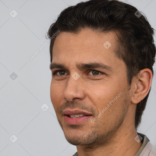 Joyful white adult male with short  brown hair and brown eyes