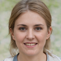 Joyful white young-adult female with medium  brown hair and blue eyes