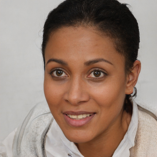 Joyful latino young-adult female with short  brown hair and brown eyes