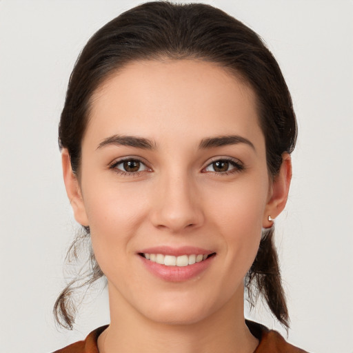 Joyful white young-adult female with medium  brown hair and brown eyes