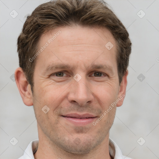 Joyful white adult male with short  brown hair and grey eyes