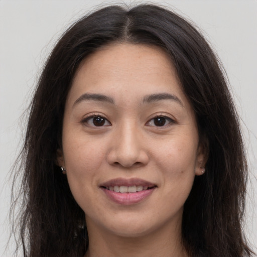 Joyful white young-adult female with long  brown hair and brown eyes