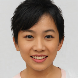 Joyful asian young-adult female with short  brown hair and brown eyes