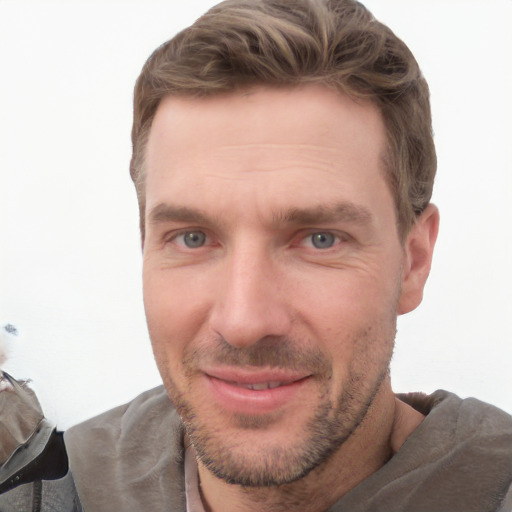 Joyful white adult male with short  brown hair and grey eyes