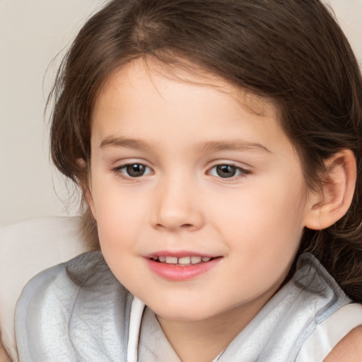 Joyful white child female with medium  brown hair and brown eyes