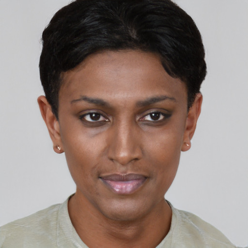 Joyful black young-adult female with short  brown hair and brown eyes