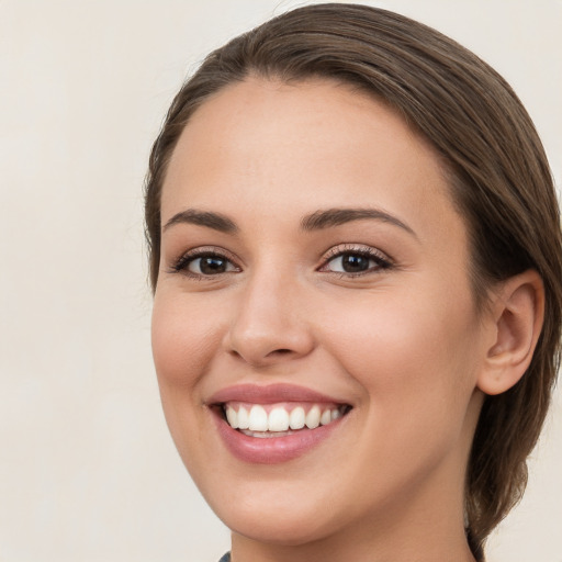 Joyful white young-adult female with medium  brown hair and brown eyes