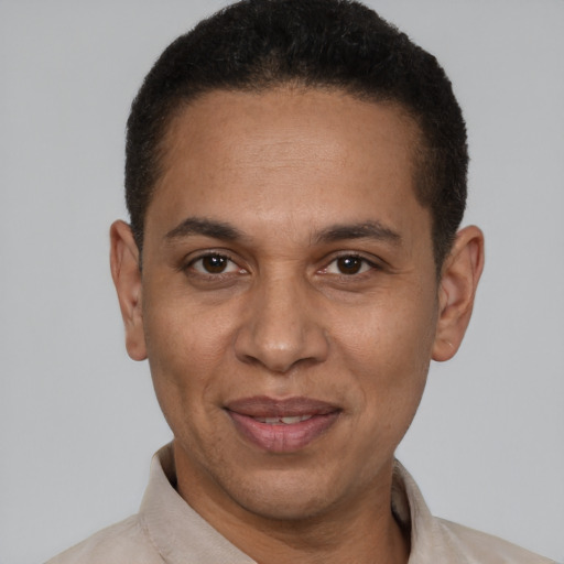 Joyful latino adult male with short  brown hair and brown eyes