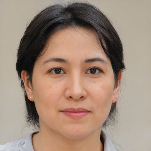 Joyful asian adult female with medium  brown hair and brown eyes