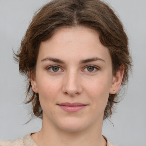 Joyful white young-adult female with medium  brown hair and green eyes