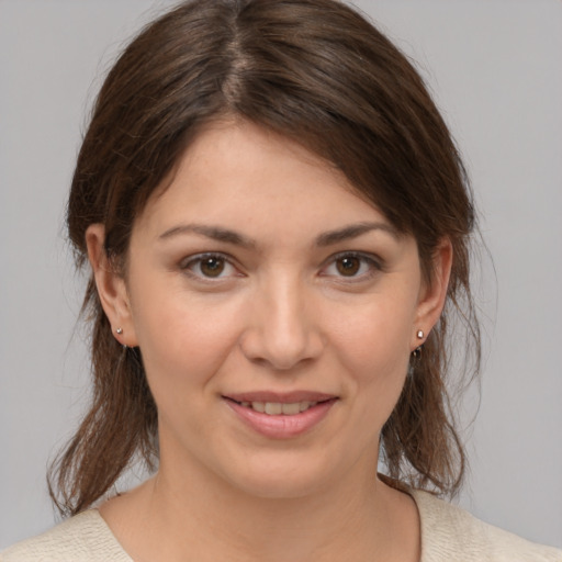 Joyful white young-adult female with medium  brown hair and brown eyes