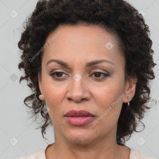 Joyful black adult female with medium  brown hair and brown eyes