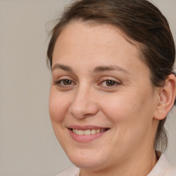 Joyful white adult female with medium  brown hair and brown eyes