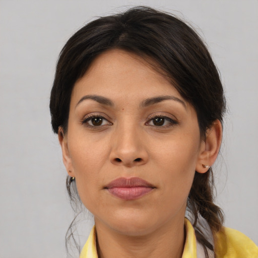 Joyful latino young-adult female with medium  brown hair and brown eyes