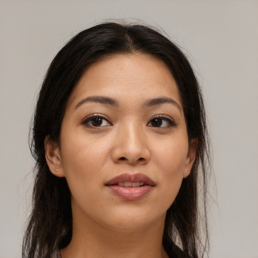 Joyful asian young-adult female with long  brown hair and brown eyes