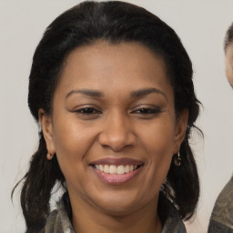 Joyful black adult female with medium  brown hair and brown eyes