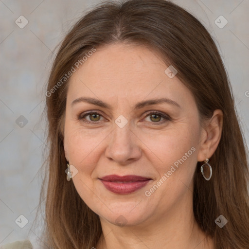 Joyful white adult female with long  brown hair and grey eyes