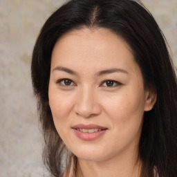 Joyful asian young-adult female with long  brown hair and brown eyes