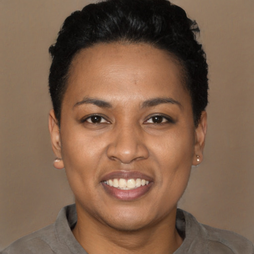 Joyful latino young-adult female with short  black hair and brown eyes