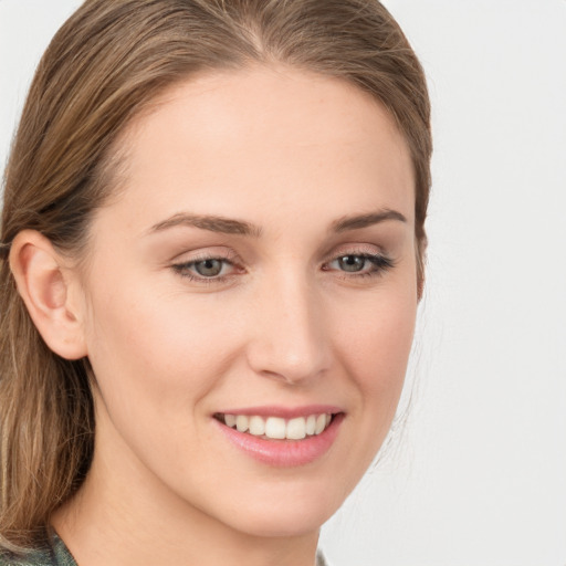 Joyful white young-adult female with long  brown hair and grey eyes