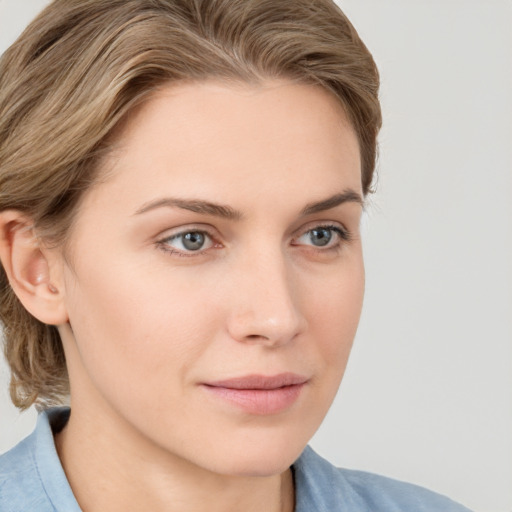 Joyful white young-adult female with medium  brown hair and blue eyes