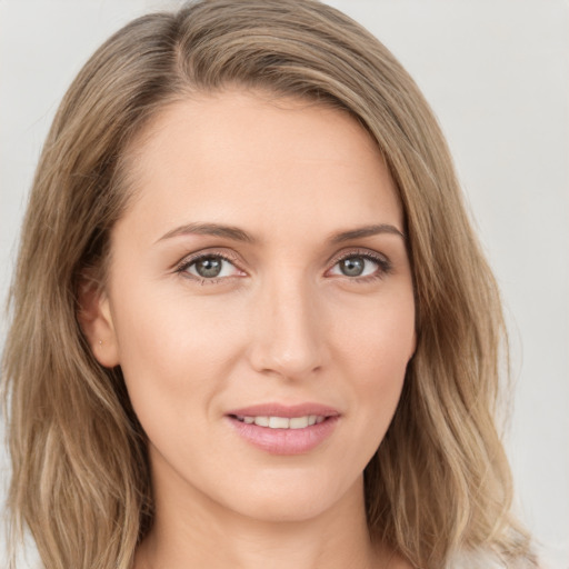 Joyful white young-adult female with long  brown hair and green eyes