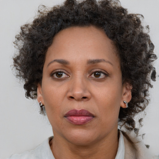 Joyful black adult female with short  brown hair and brown eyes