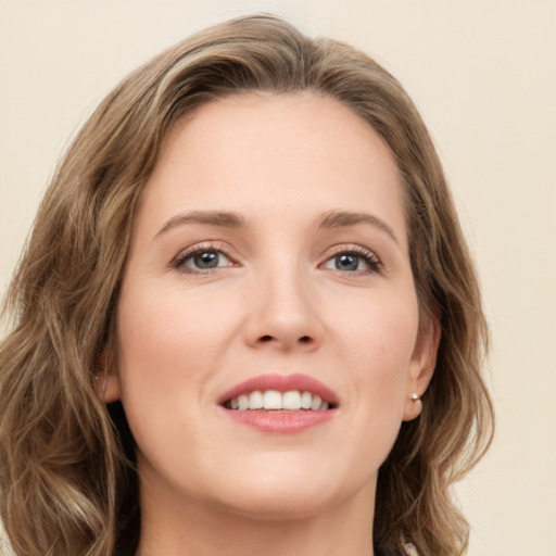 Joyful white young-adult female with long  brown hair and green eyes