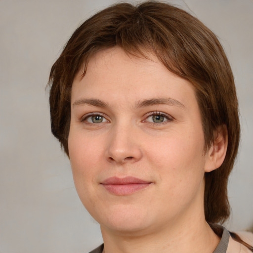 Joyful white young-adult female with medium  brown hair and grey eyes