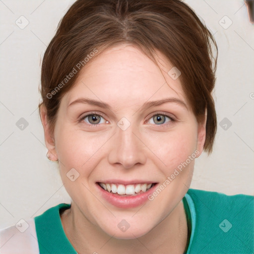 Joyful white young-adult female with short  brown hair and blue eyes