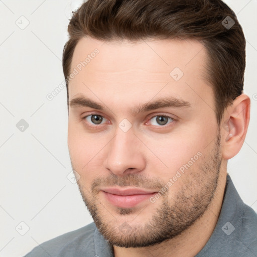 Joyful white young-adult male with short  brown hair and brown eyes