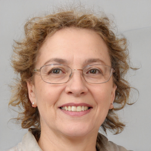 Joyful white middle-aged female with medium  brown hair and blue eyes