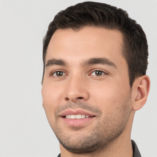 Joyful white young-adult male with short  brown hair and brown eyes