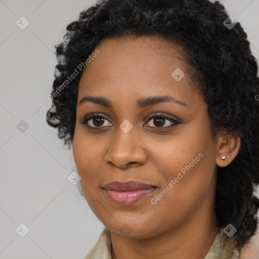 Joyful black young-adult female with long  black hair and brown eyes