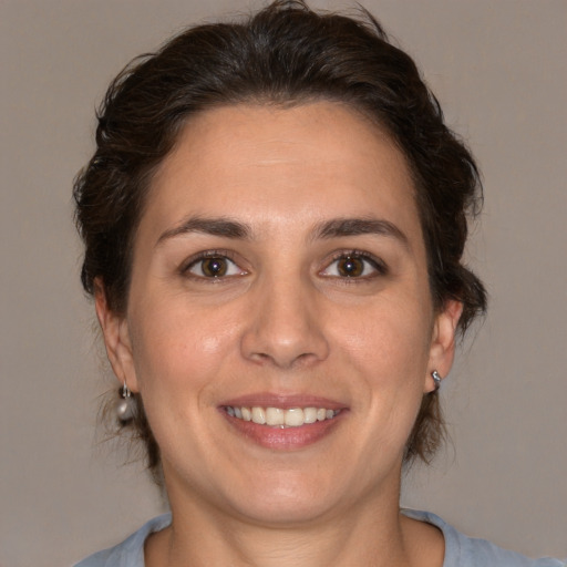 Joyful white adult female with medium  brown hair and brown eyes