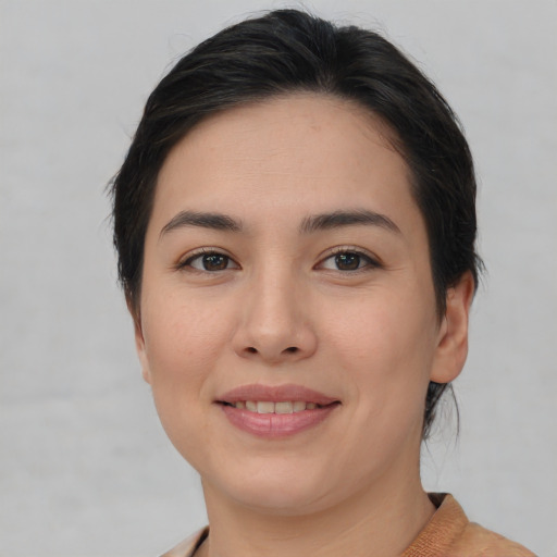 Joyful white young-adult female with medium  brown hair and brown eyes