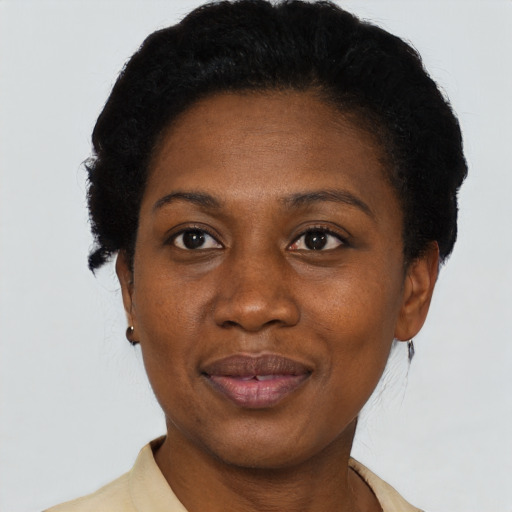 Joyful black adult female with short  black hair and brown eyes