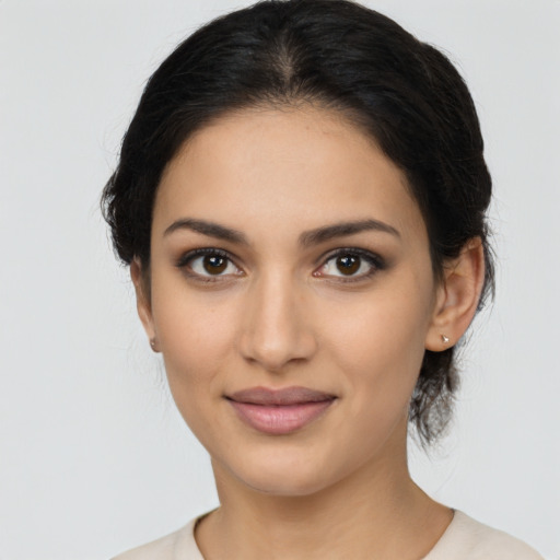 Joyful latino young-adult female with medium  brown hair and brown eyes