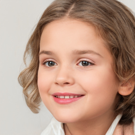 Joyful white child female with medium  brown hair and brown eyes