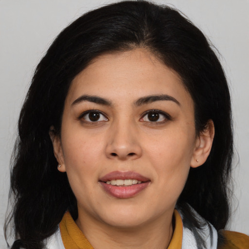 Joyful latino young-adult female with medium  brown hair and brown eyes