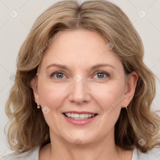 Joyful white adult female with medium  brown hair and blue eyes