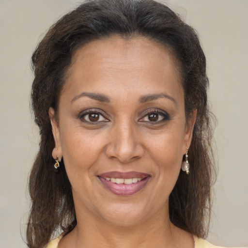 Joyful black adult female with medium  brown hair and brown eyes