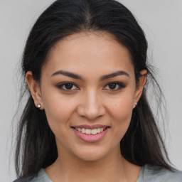 Joyful latino young-adult female with long  brown hair and brown eyes