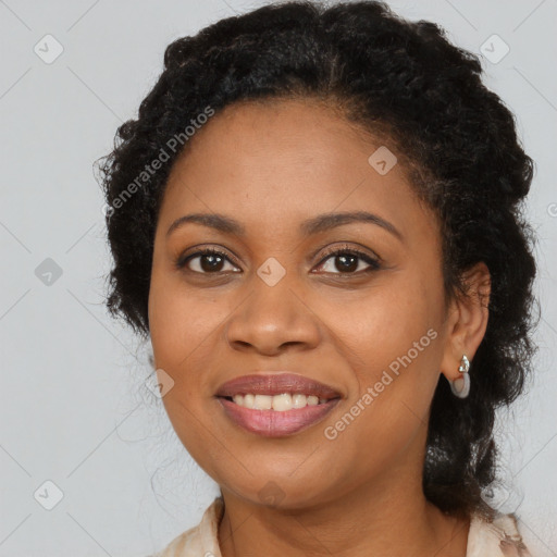 Joyful black young-adult female with long  brown hair and brown eyes