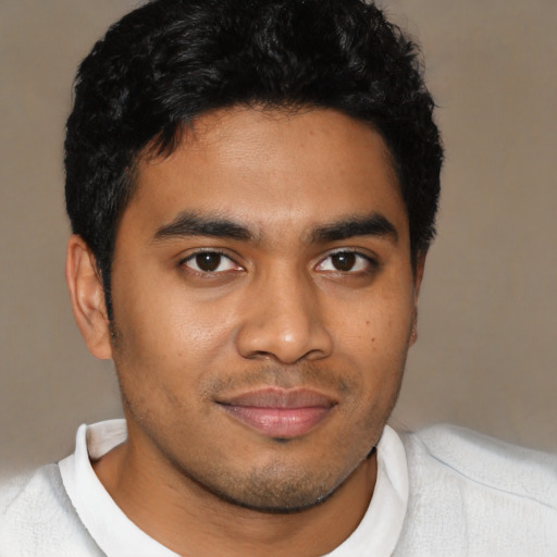 Joyful latino young-adult male with short  black hair and brown eyes