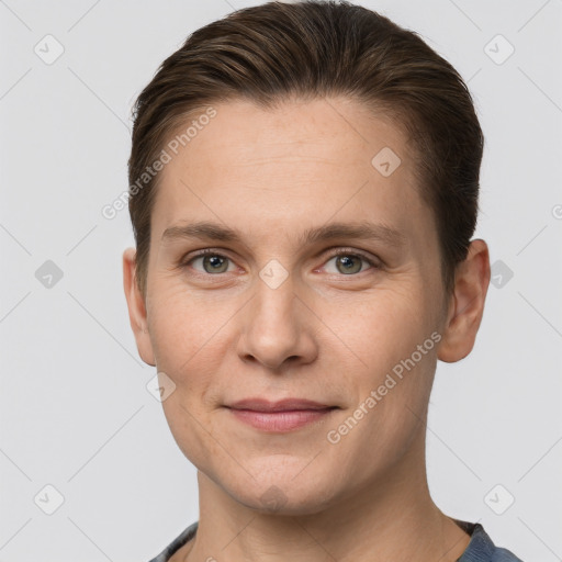 Joyful white young-adult female with short  brown hair and grey eyes